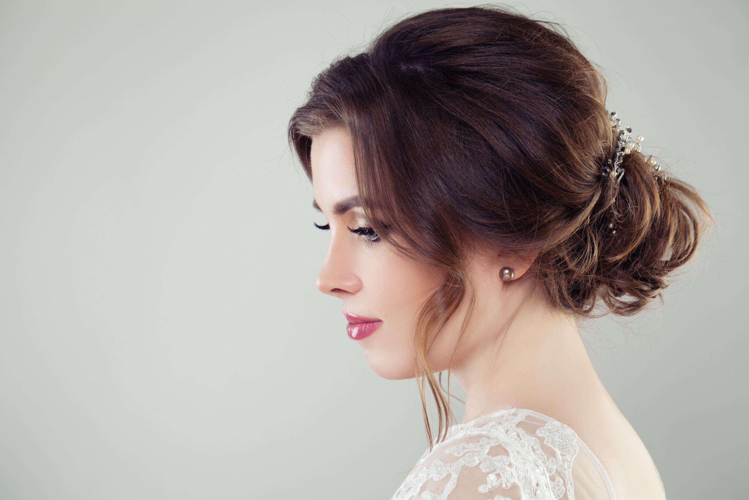 Pretty bride woman with bridal hair. Updo haircut with pearls hairdeco, face closeup