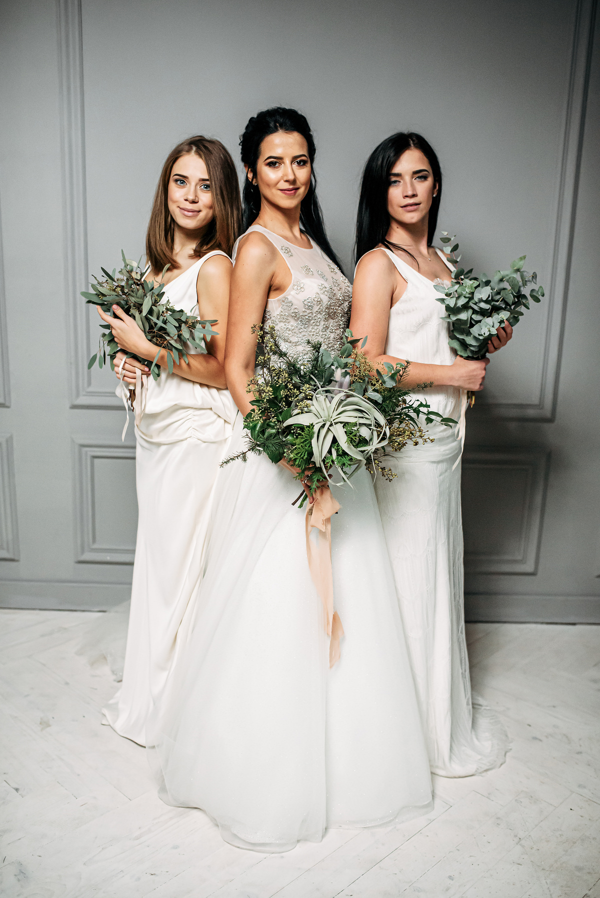 Bride and bridesmaid three together in dresses